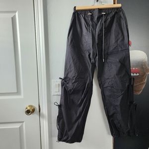 Black drawstring pants with bow detail